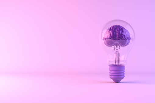 Ideas concept, brain inside the light bulb on colorful background.
