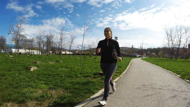 istock Woman running in park 1146605648