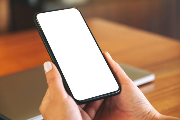 istock woman's hands holding black mobile phone with blank white screen 1146605768