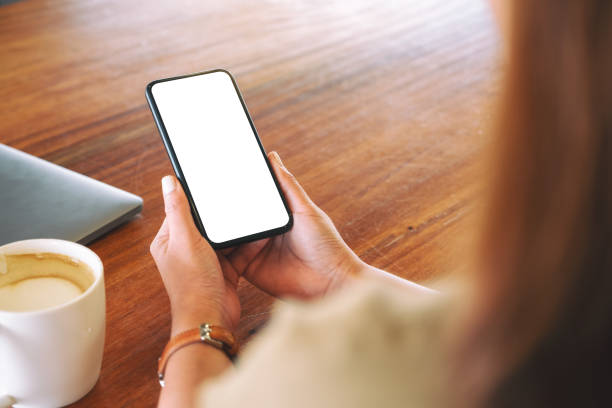 istock a woman holding black mobile phone with blank desktop screen 1146605791