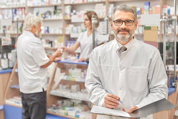 istock Happy chemist smiling, posing in pharmacy. 1146610319