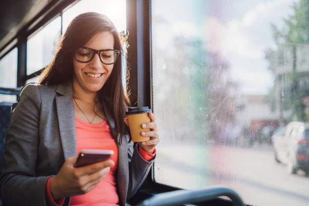 istock Young woman using phone on a city bus ride 1146610588