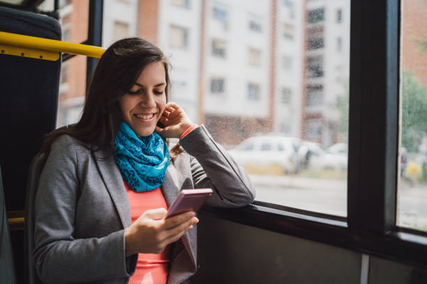 istock Young woman using phone on a city bus ride 1146610628