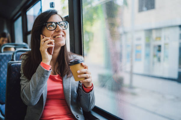 istock Young woman using phone on a city bus ride 1146610679
