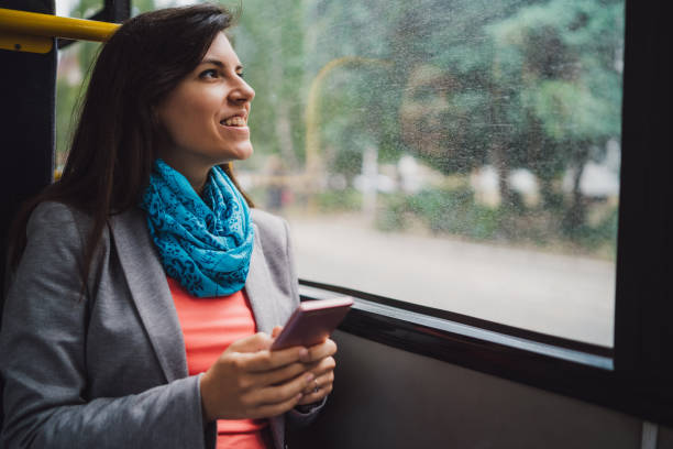 istock Young woman using phone on a city bus ride 1146610717