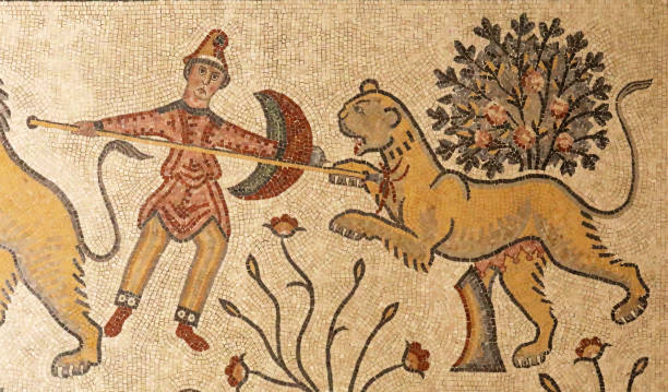 Man killing lioness in ancient mosaics of Mount Nebo, Jordan Detail of a man killing a lioness from ancient mosaics of Mount Nebo, Jordan mount nebo jordan stock pictures, royalty-free photos & images