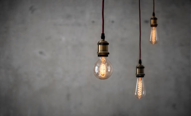 istock Vintage Edison bulbs in front of concrete wall 1146616280