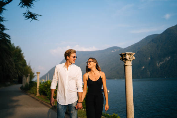 istock Couple walk along promenade at sunset 1146617629