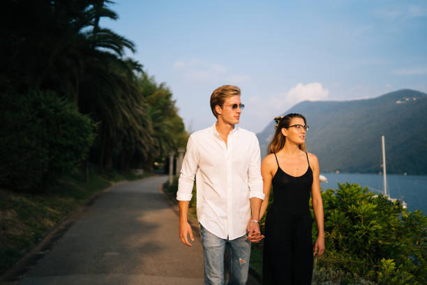 istock Couple walk along promenade at sunset 1146617702