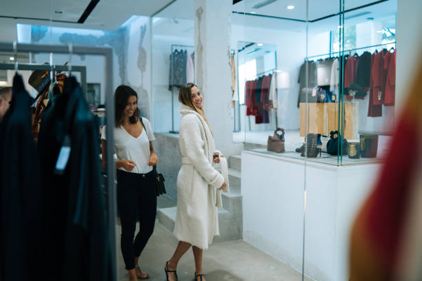 istock Friends smile at each other while trying on outfits 1146618247