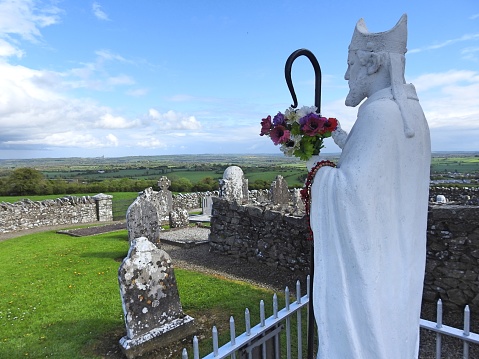 St Patrick on the Hill of Slane with panoramic views of the Irish countryside in the background.