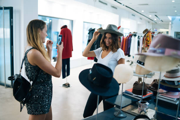 istock Friends smile at each other while trying on outfits 1146618314