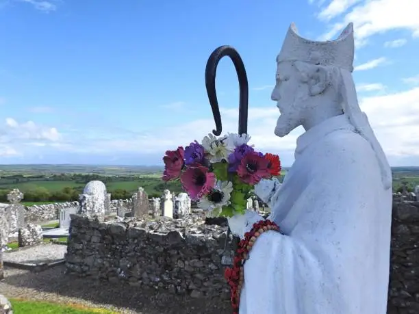 St Patrick on the Hill of Slane with panoramic views of the Irish countryside in the background.