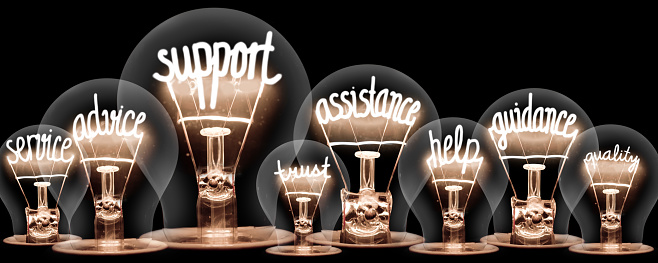 Photo of light bulbs group with shining fibers in a shape of SUPPORT concept related words isolated on black background