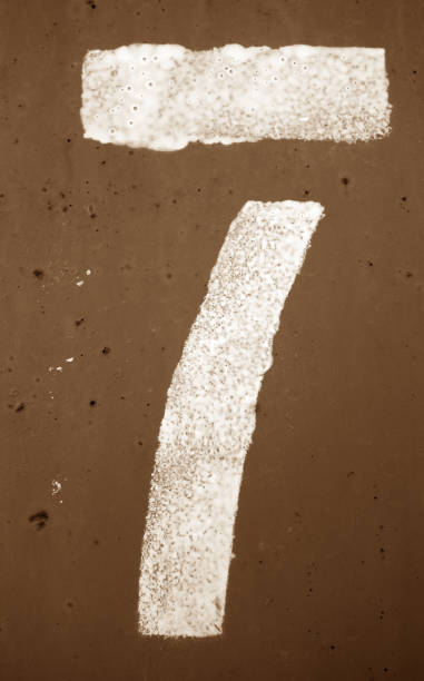 istock Number 7 in stencil on metal wall in brown tone. 1146619382