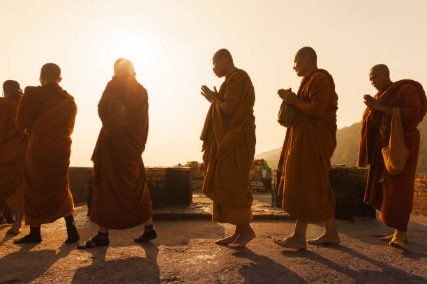 Sacred place on the mountain of Gridhakuta Buddhist monks in traditional Burmese clothes make kora around the sacred place on the mountain of Gridhakuta where Buddha gave the lectures. India. Rajgir, on February 1, 2014 theravada photos stock pictures, royalty-free photos & images