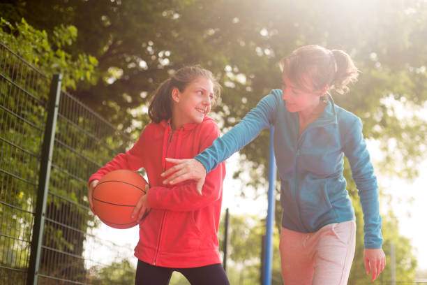 istock Mother and daughter playing basketball 1146619781