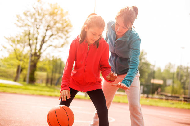 istock Mother and daughter playing basketball 1146619974