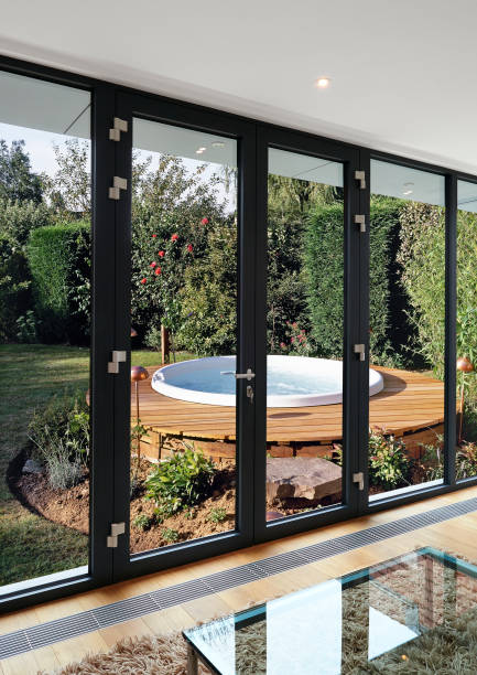 istock Windows and doors against lush foliage garden and bubbles pool 1146620174