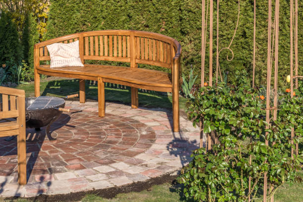 istock Lovingly designed garden with stone circle, wooden benches and fire bowl 1146622420