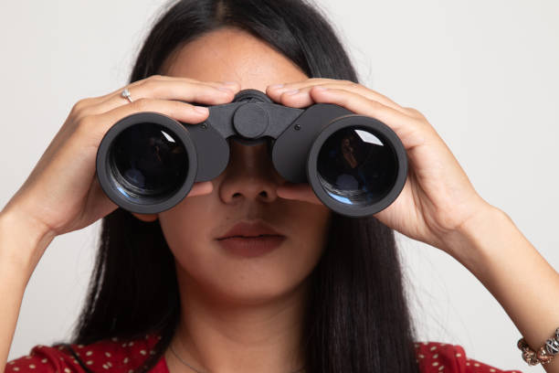 istock Young Asian woman with binoculars. 1146623021