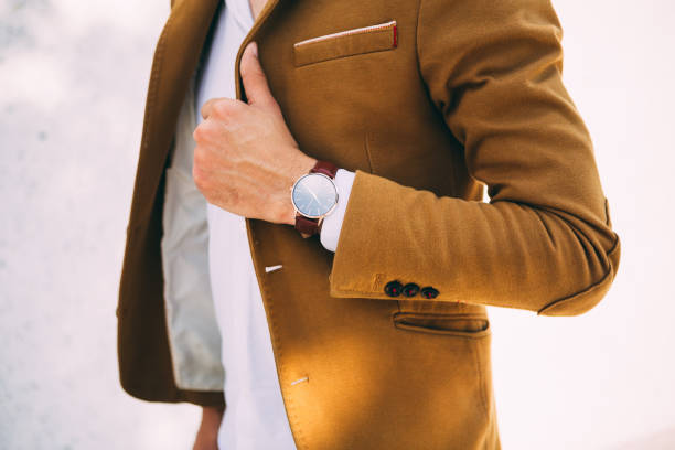istock Young Man in Suit Wearing Analog Watch 1146629501