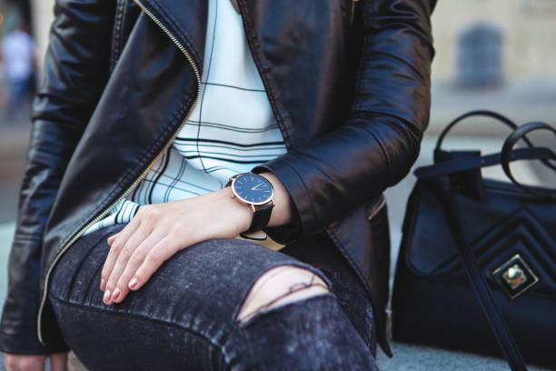 istock Young woman checking the time on watch 1146629876