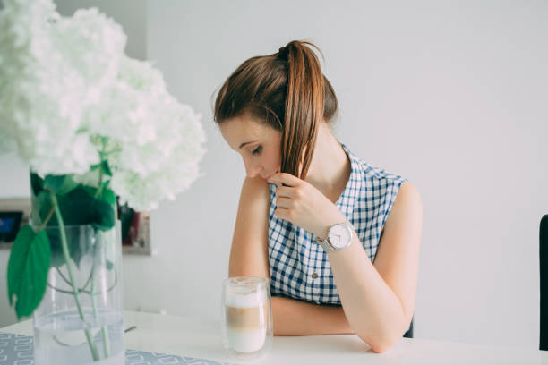 Portrait of Young Woman inside coffee shop with Watch on her hand and coffee