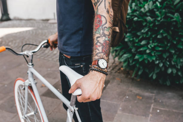 istock Young Man with Bicycle Wearing Analog Watch 1146630828