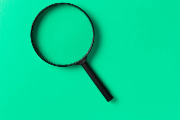 istock Magnifying glass on Mint background. Top view. Flat lay. Copy space. Minimal creative concept. Search concept. Neo Mint color of the year 2020 1146632401