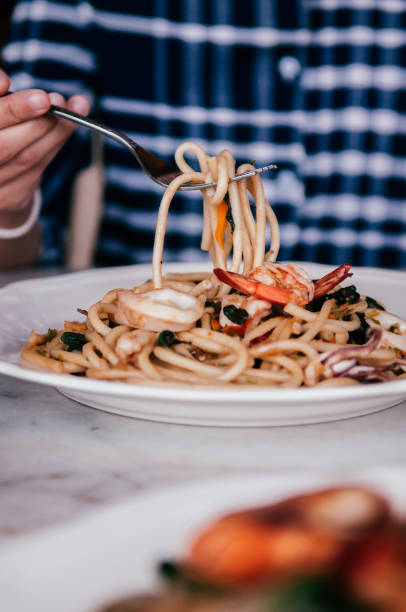 istock Picking Bucatini Twisted seafood Italian pasta 1146632848
