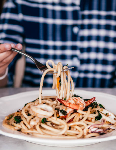 istock Picking Bucatini Twisted seafood Italian pasta 1146632956