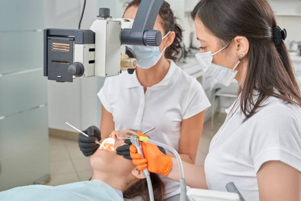 istock Patient lying on dental chair while dentist treating teeth 1146635132