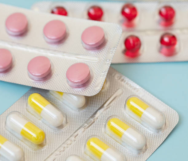 istock Colorful antibacterials pills on blue background. 1146636771