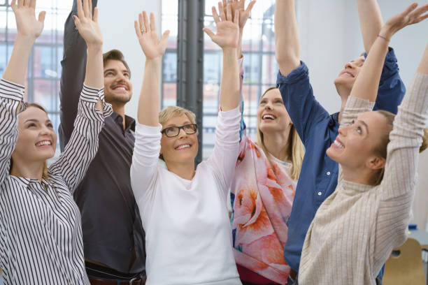 istock Group of successful business people cheering 1146637661