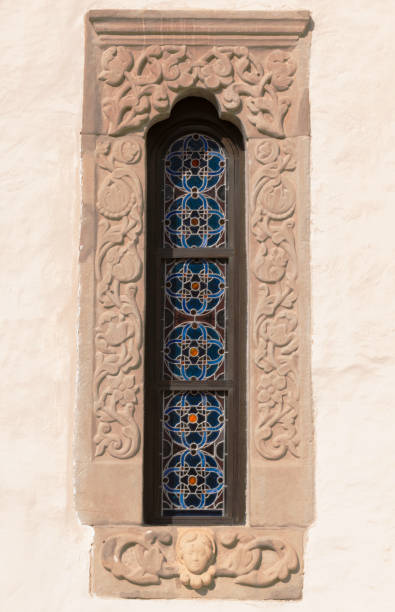 istock old, stone carved windows frame with stained glass motif 1146638826