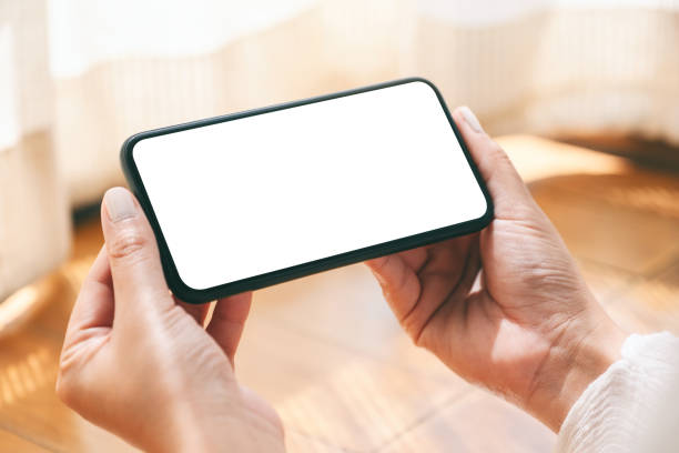 istock Mockup image of hands holding and using black mobile phone with blank desktop screen horizontally 1146641333
