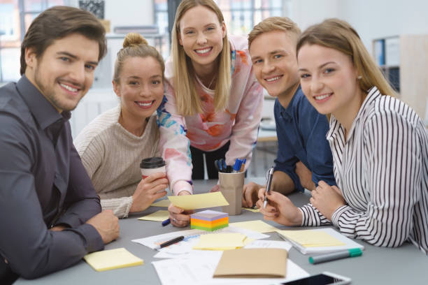 Friendly smiling young business team stock photo