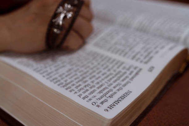 istock selective focus holy bible book and  cross in hand  for background and inspiration 1146643600