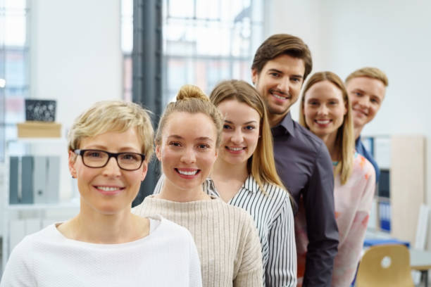 istock Happy office work team in an ascending portrait 1146645392