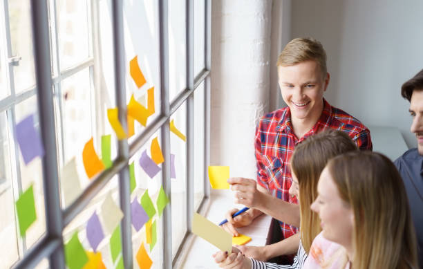 istock Laughing office team meeting with sticky notes 1146646828