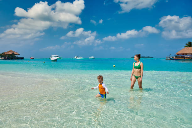 istock Toddler boy on beach with mother 1146650369