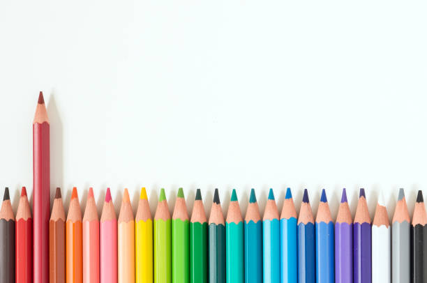 istock Closeup of coloured pencils lined up in a row on white background copy space 1146651462