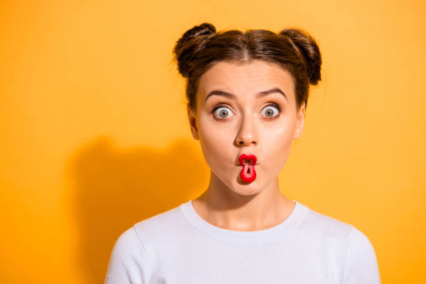 Close up photo beautiful she her lady pretty hairdo two buns big eyes fish-face foolish ridiculous hilarious idiotic facial expression wear casual white pullover clothes isolated yellow background Close up photo beautiful she her lady pretty hairdo two buns big eyes fish-face foolish ridiculous hilarious idiotic facial expression wear casual white pullover clothes isolated yellow background. gurning stock pictures, royalty-free photos & images