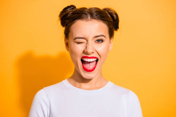 close up portrait of lovely cute funny lady making winks opening her mouth shouting yeah having holidays dressed in white comfortable clothing isolated on bright background - make up cosmetics beauty lipstick imagens e fotografias de stock