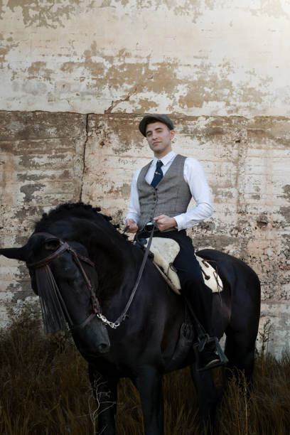 istock Close up classic man riding a black horse 1146655314