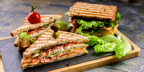 Food banner toast sandwich with smoked beef, cheese, tomatoes and lettuce. Traditional breakfast or lunch