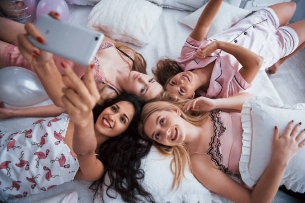 istock Taking selfie with friends while lying on the bed at bachelorette party 1146658881