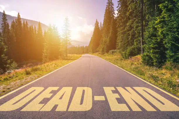 Dead-end written on road in the mountains. Dead-end text on the road.