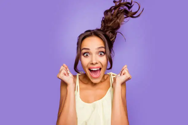 Close-up photo portrait of cool in summer casual clothing astonished delightful she her lady raising hands fists up wants to go shopping sale season isolated violet background.